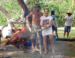 Cheryl and Otis cooking a pig for Jenny's birthday