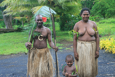 Chief Kerely Malau, his wife, Elizabeth, and son, Dudley, wearing traditional costumes