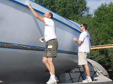 Pete and Alex conduct tack rag wipe and inspection prior to spraying topcoat.