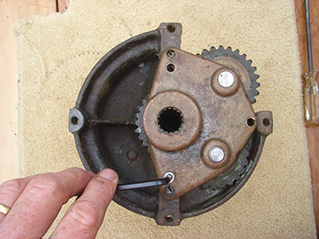 Unscrew the bottom plate to expose the gears. 
