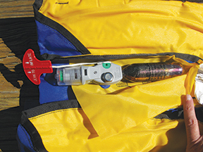 Live vest auto inflate mechanism, note green tabs showing unit is armed