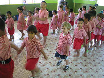 Rufo, in sneakers, marching into Samoan kindergarten, Apia