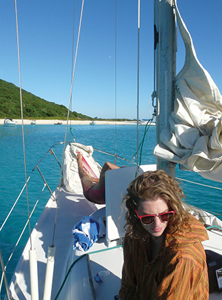 Co-owner Rachel, relaxes onboard while anchored off St. Croix's Buck Island