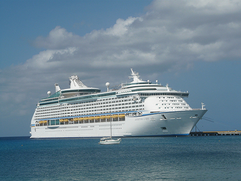 The 27-foot Cruzan Time dwarfed by a cruise ship off Frederiksted on St. Croix's west end