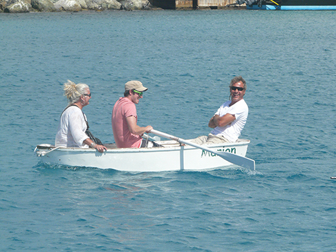 The author inexpertly rows fellow co-owners in Cruzan Time, Amanda Brilliante and Carsten Breuer, shortly after the purchase of their rowing dinghy, Marion