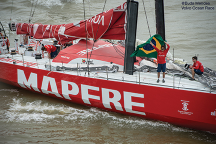 April 19, 2015. Dock out of the start of Leg 6 to Newport. Brazilian MAPFRE crew member, Andre Fonseca, aka Bochecha, waves the crowds with the country flag.