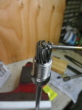 D Wedge is installed over inner wires with 1/8” of wire extending beyond the cone. A 1/8” drill bit is used as a measuring gauge here. The outer wires are wrapped around the wedge taking care to keep any out of the slots in the cone. A small screwdriver is helpful for manipulating the individual wires.